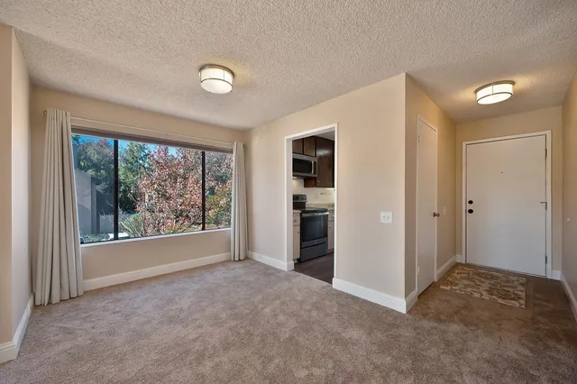 a kitchen with granite countertop wooden cabinets a stove and a sink