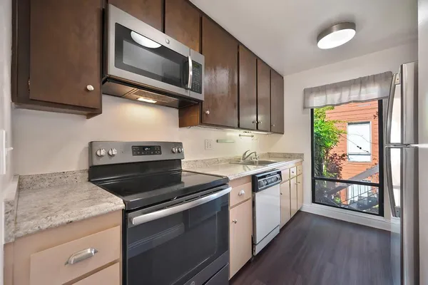 a kitchen with a stove and a refrigerator