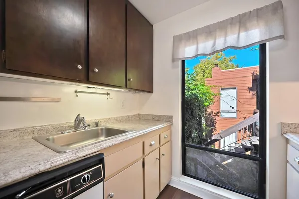 a kitchen with a refrigerator and window
