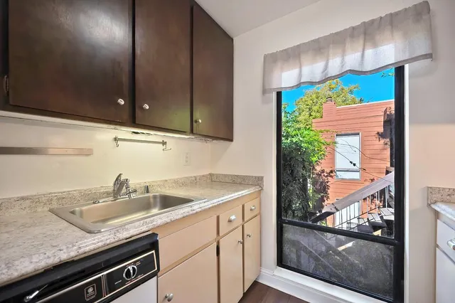 a kitchen with a refrigerator and window