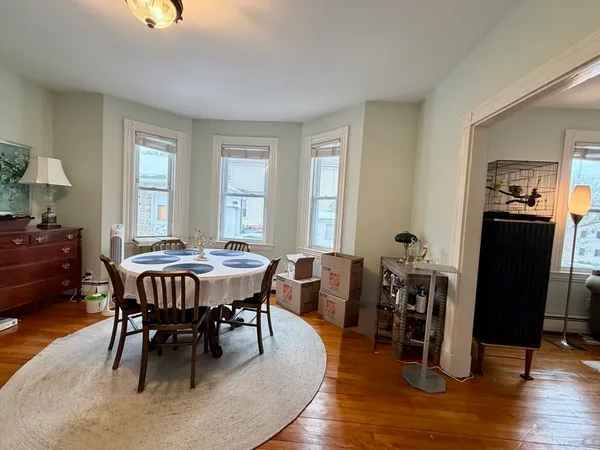 a view of a dining room with furniture window and wooden floor
