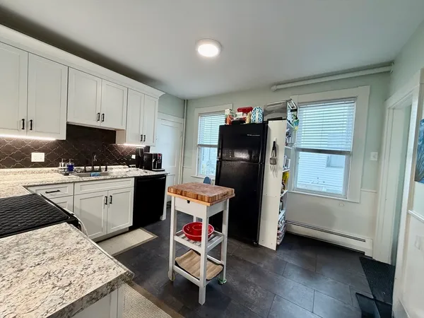 a kitchen with refrigerator and window