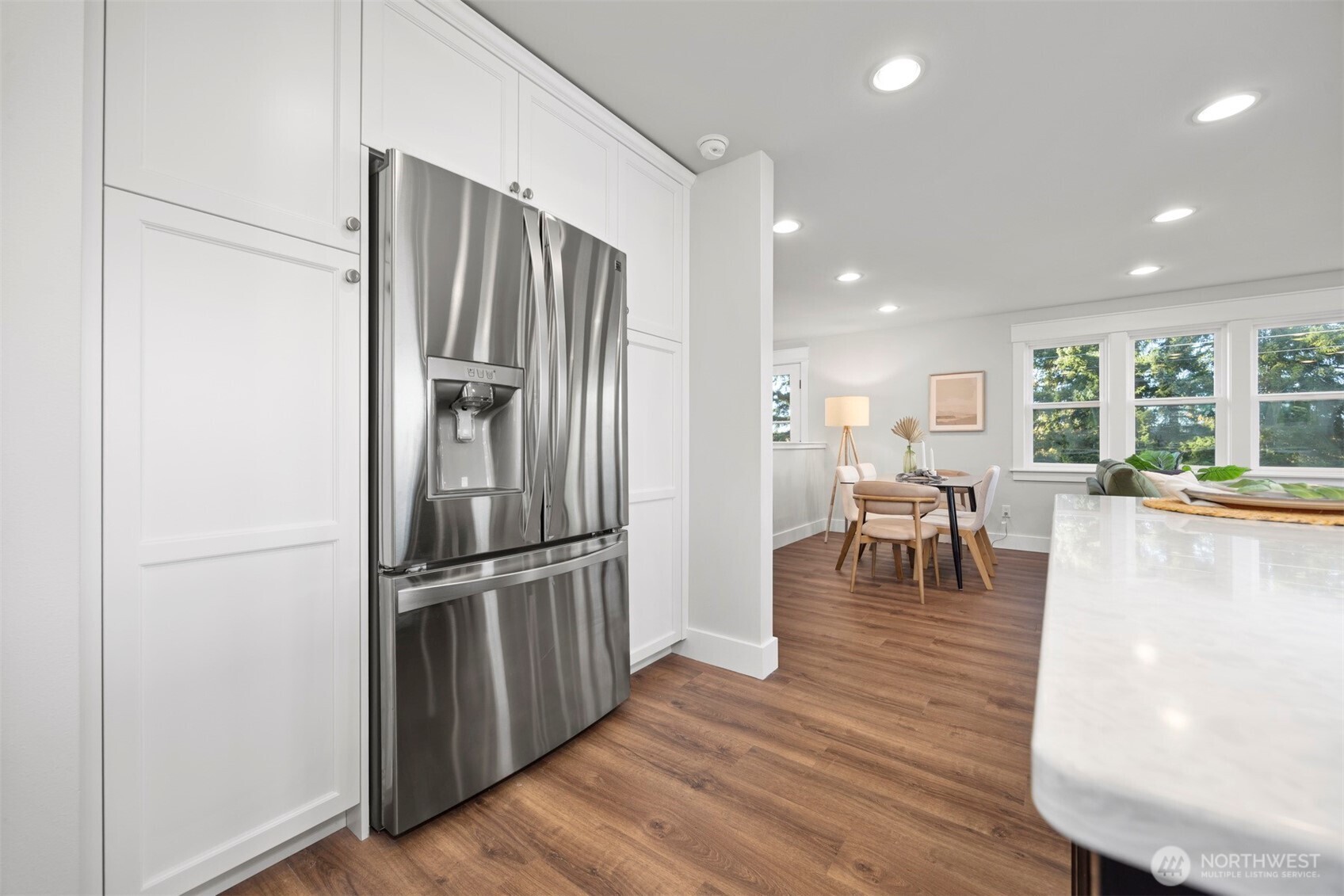 3505 East Smith Road Bellingham, WA 98226 - Photo 15 of 40 a kitchen with stainless steel appliances refrigerator dining table and chairs