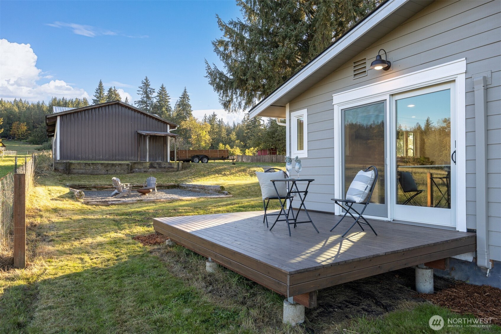 3505 East Smith Road Bellingham, WA 98226 - Photo 6 of 40 a view of a patio with table and chairs with wooden floor and fence