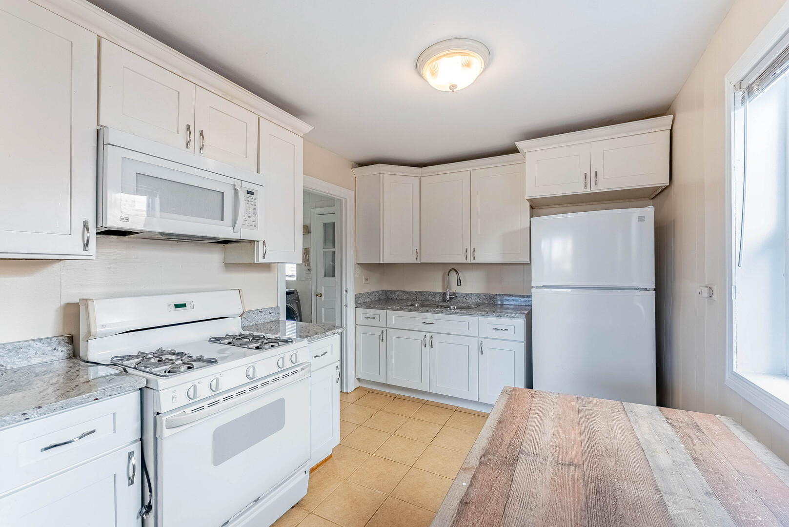 16154 Honore Avenue Markham, IL 60428 - Photo 12 of 32 a kitchen with granite countertop white cabinets and white appliances