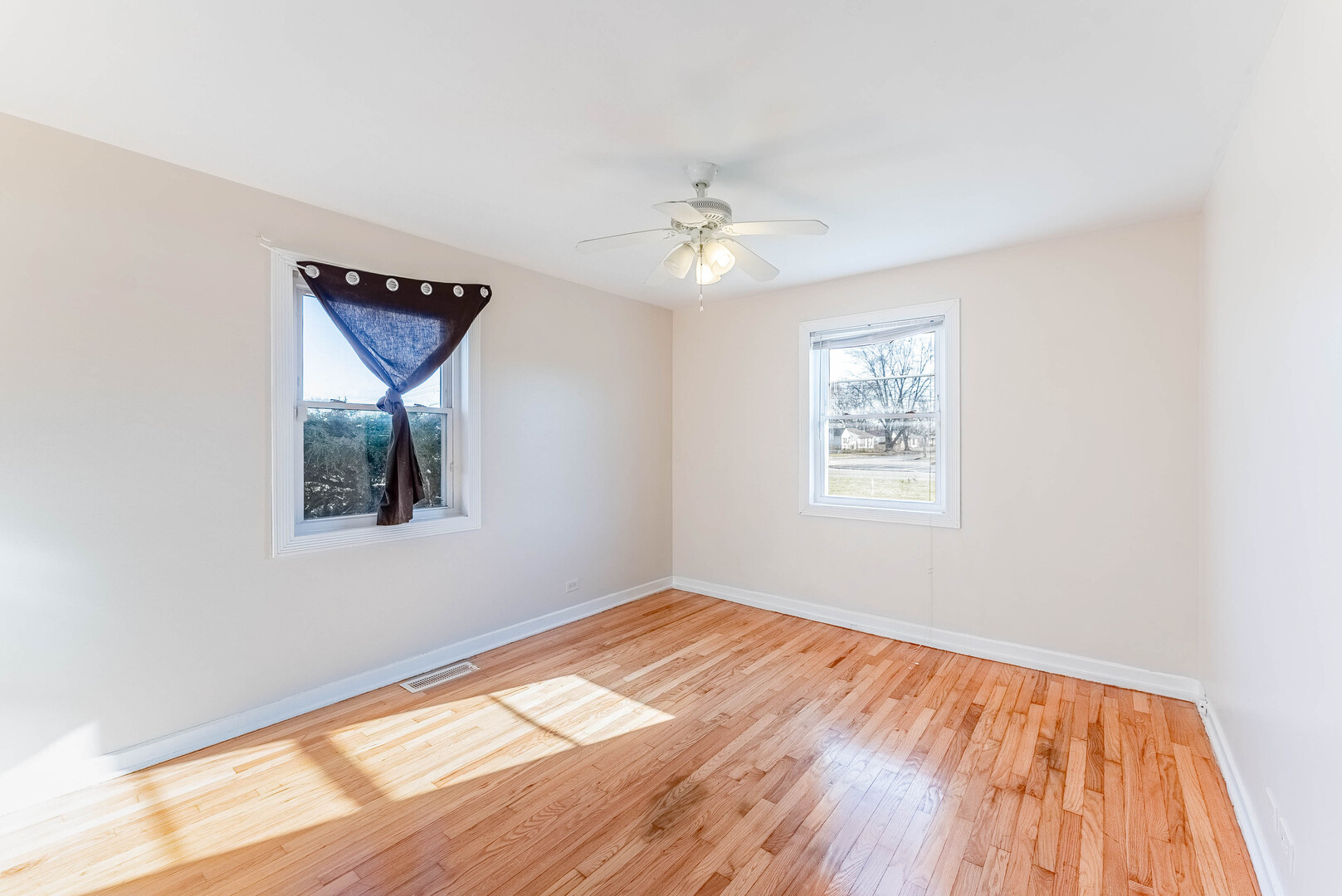 16154 Honore Avenue Markham, IL 60428 - Photo 15 of 32 a view of empty room with wooden floor and fan