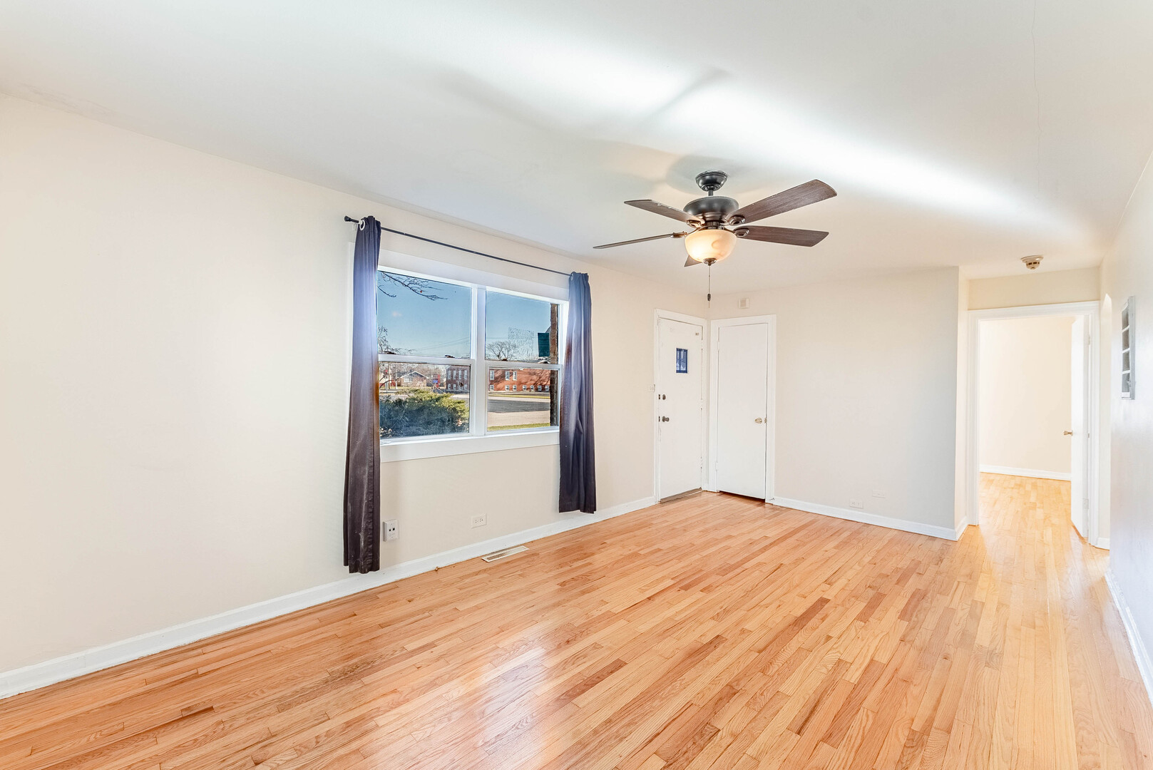 16154 Honore Avenue Markham, IL 60428 - Photo 7 of 32 a view of an empty room with wooden floor
