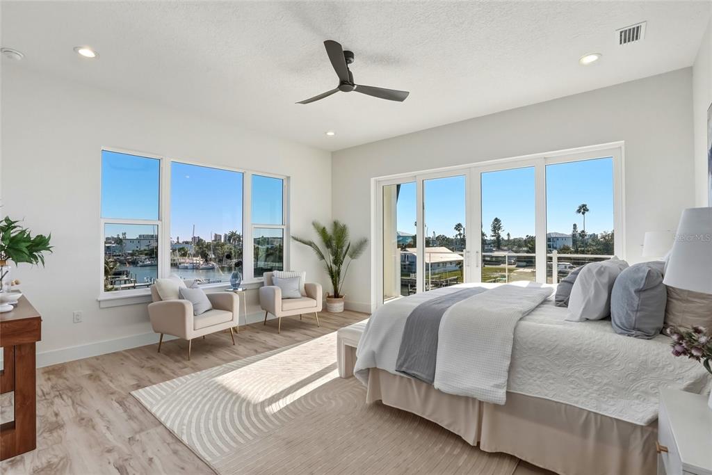 534 Crystal Drive Madeira Beach, FL 33708 - Photo 27 of 68 a bedroom with a large bed and a large window