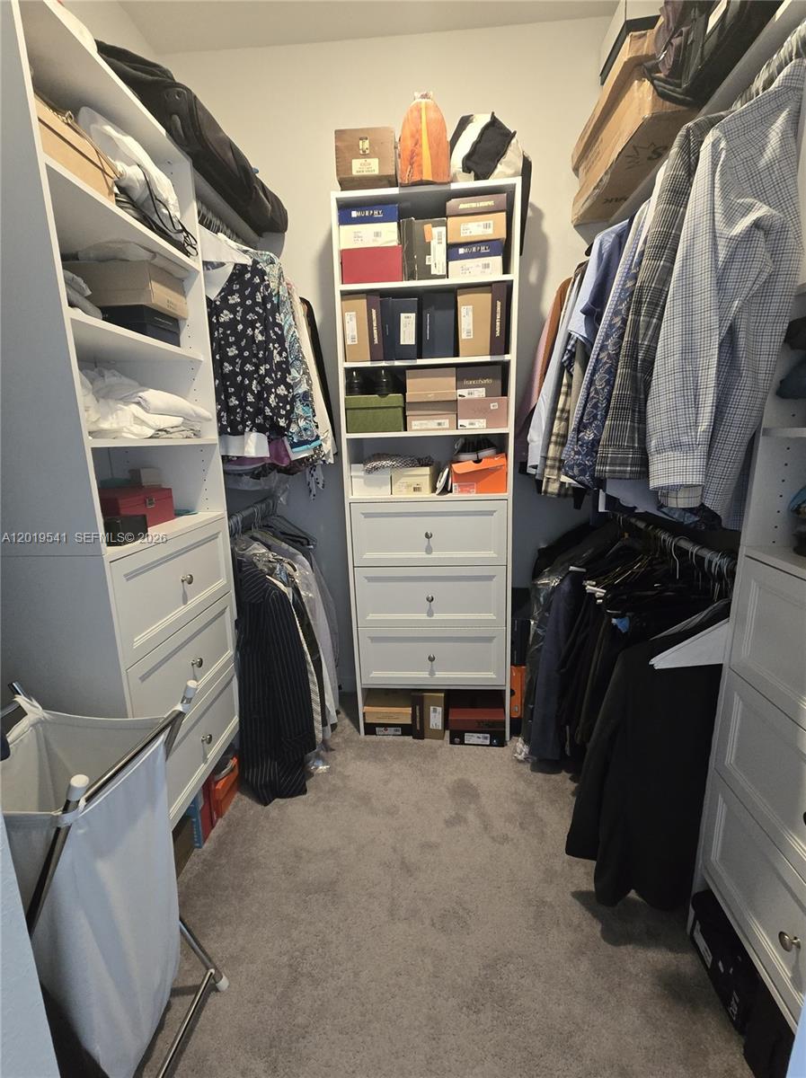 24400 Southwest 119th Place Homestead, FL 33032 - Photo 12 of 22 a view of walk in closet with clothes and shoes