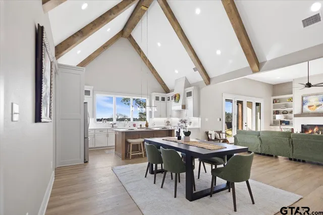 a dining hall with stainless steel appliances a table and chairs