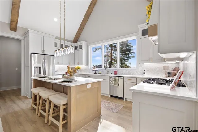 a kitchen with a stove a sink and a refrigerator