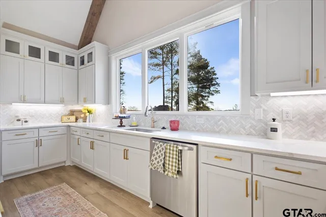 a kitchen with a sink stove and cabinets