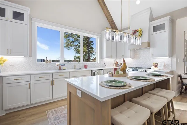a kitchen with a sink stove and cabinets