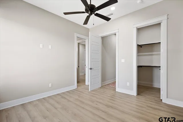 a view of a room with wooden floor and entryway