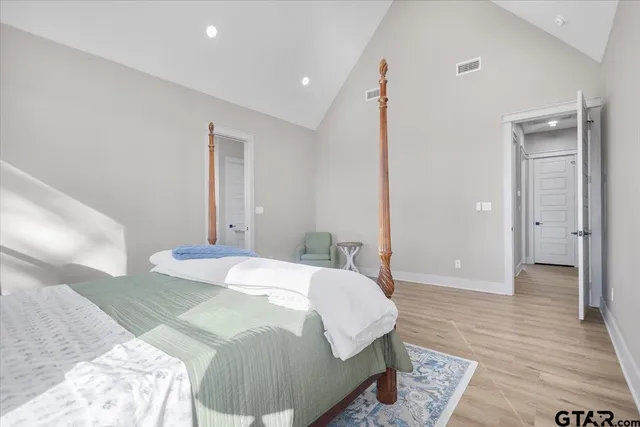 a bedroom with a bed and a mirror