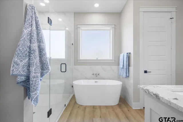 a white bath tub sitting next to a white sink