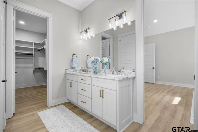 a bathroom with a double vanity sink and a mirror