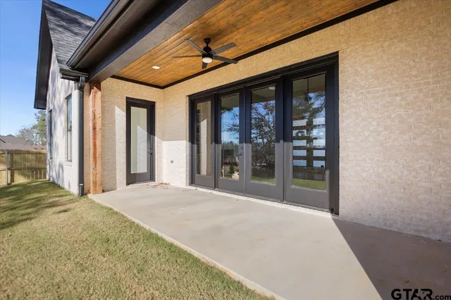 a large room with large windows and a bed