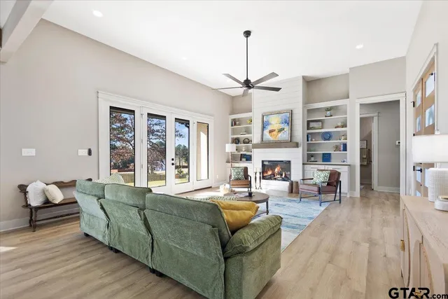 a living room with furniture and a chandelier