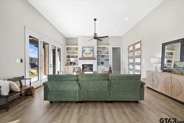 a living room with furniture and a wooden floor