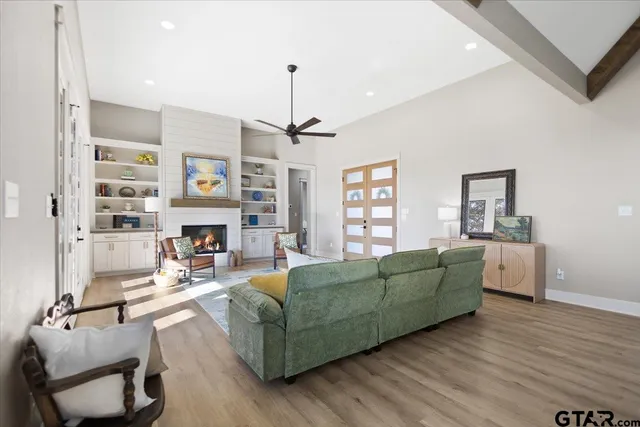a living room with furniture window and a wooden floor