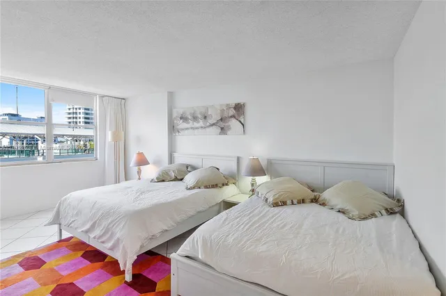 a bedroom with two beds and painting on the wall