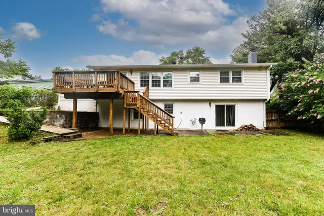 a view of a house with a yard and sitting area