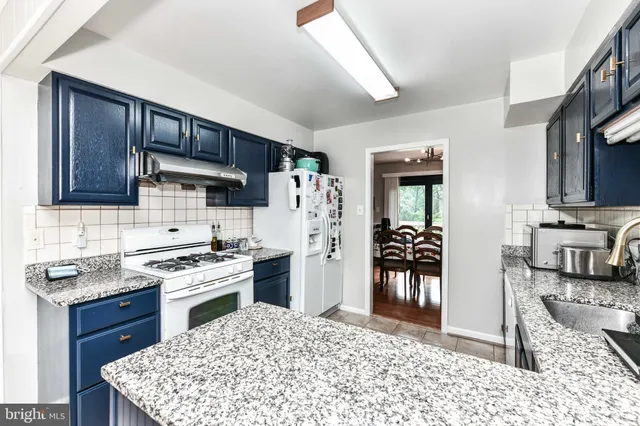 a kitchen with a stove a refrigerator and a sink