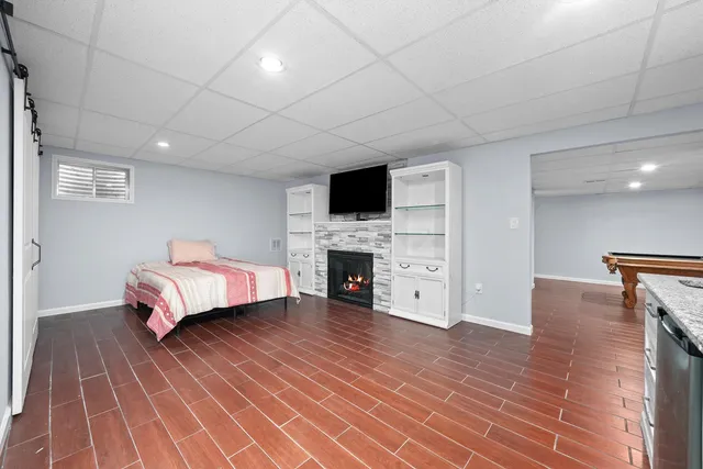 a spacious bedroom with a bed and a fireplace