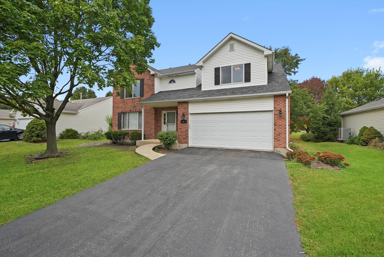497 Pheasant Chase Drive Bolingbrook, IL 60490 - Photo 2 of 33 a front view of a house with a yard and garage