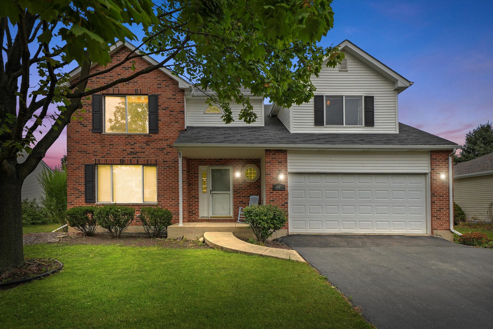 497 Pheasant Chase Drive Bolingbrook, IL 60490 - Photo 29 of 33 a front view of a house with a yard and garage