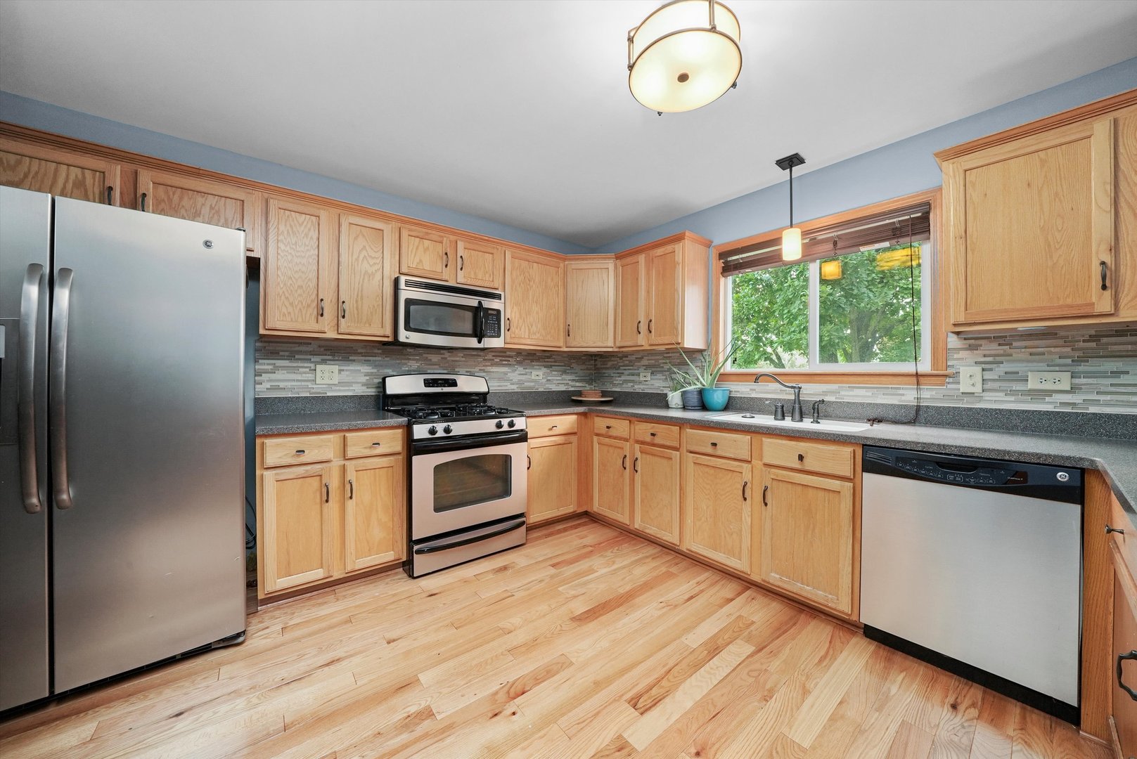 497 Pheasant Chase Drive Bolingbrook, IL 60490 - Photo 6 of 33 a kitchen with granite countertop white cabinets and stainless steel appliances