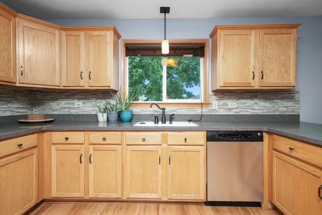 a kitchen with granite countertop white cabinets and white appliances