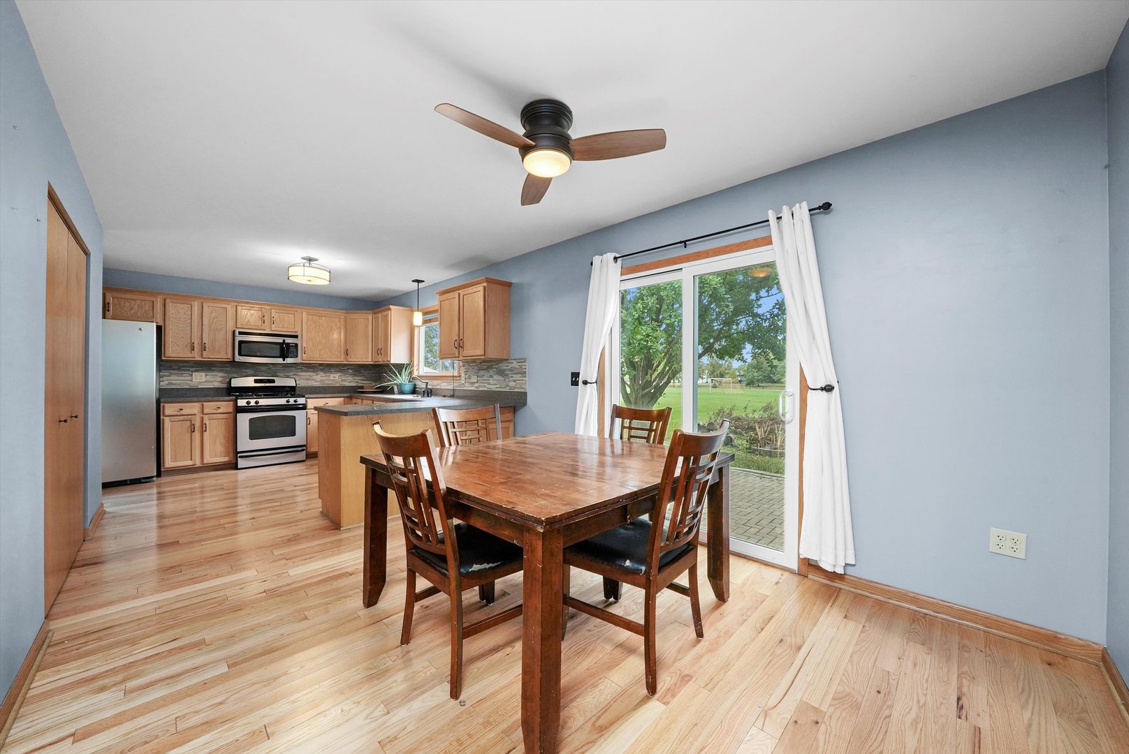 497 Pheasant Chase Drive Bolingbrook, IL 60490 - Photo 9 of 33 a view of a dining room with furniture window and wooden floor