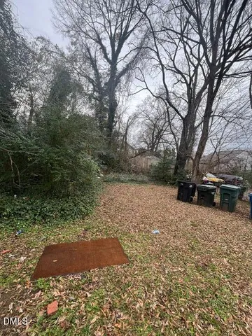 a view of yard covered with snow in front of house