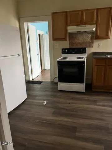 a kitchen with wooden floors and a stove