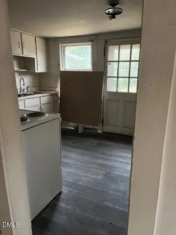 a kitchen with a refrigerator a sink and cabinets