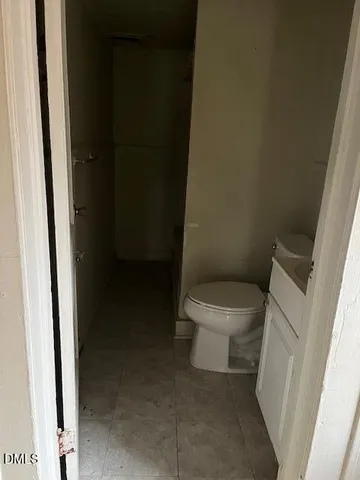 a white toilet sitting next to a sink