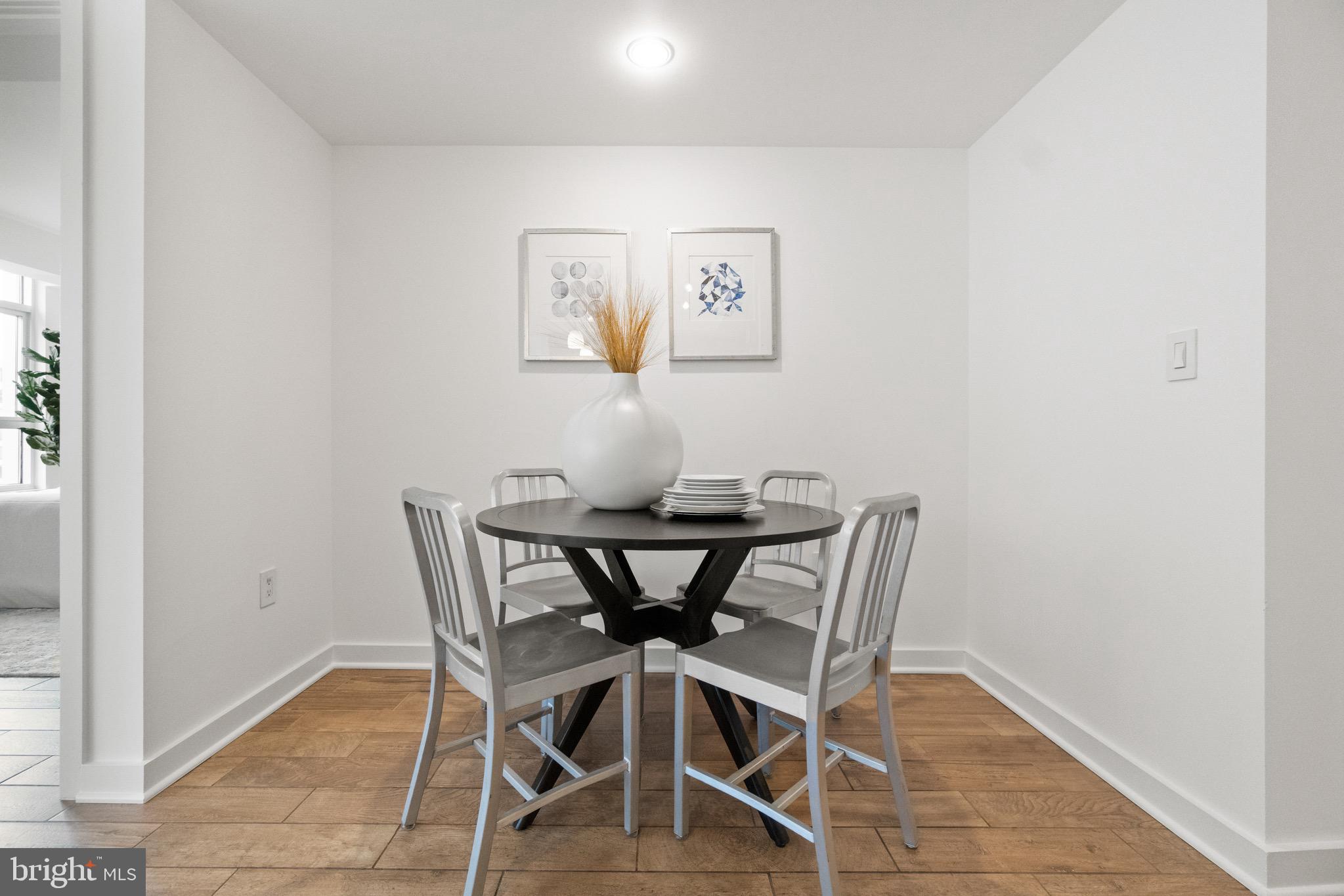 1025 First Street Southeast, Unit 1010 Washington, DC 20003 - Photo 13 of 36 a view of a dining room with furniture and wooden floor