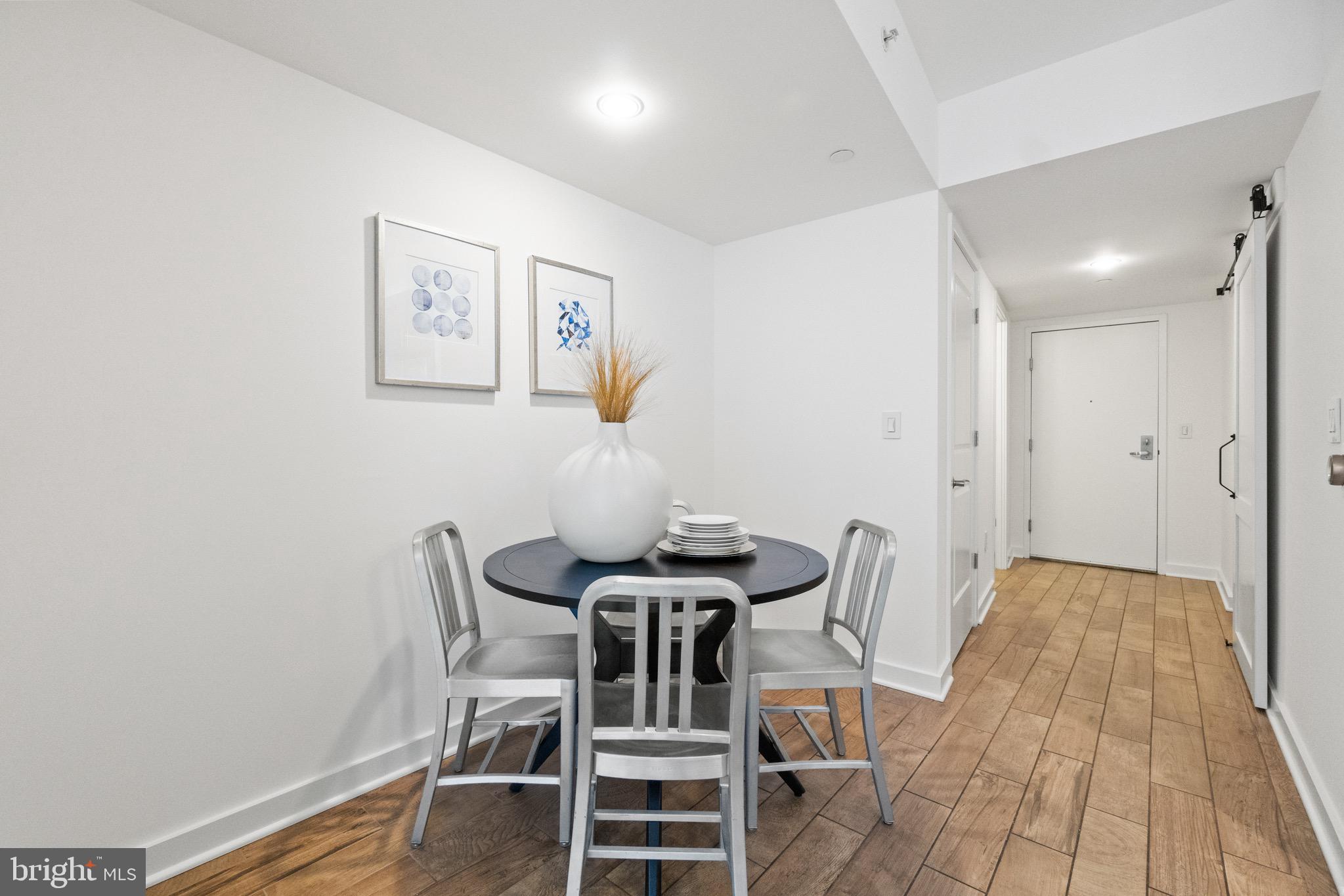1025 First Street Southeast, Unit 1010 Washington, DC 20003 - Photo 14 of 36 a view of a dining room with furniture and wooden floor