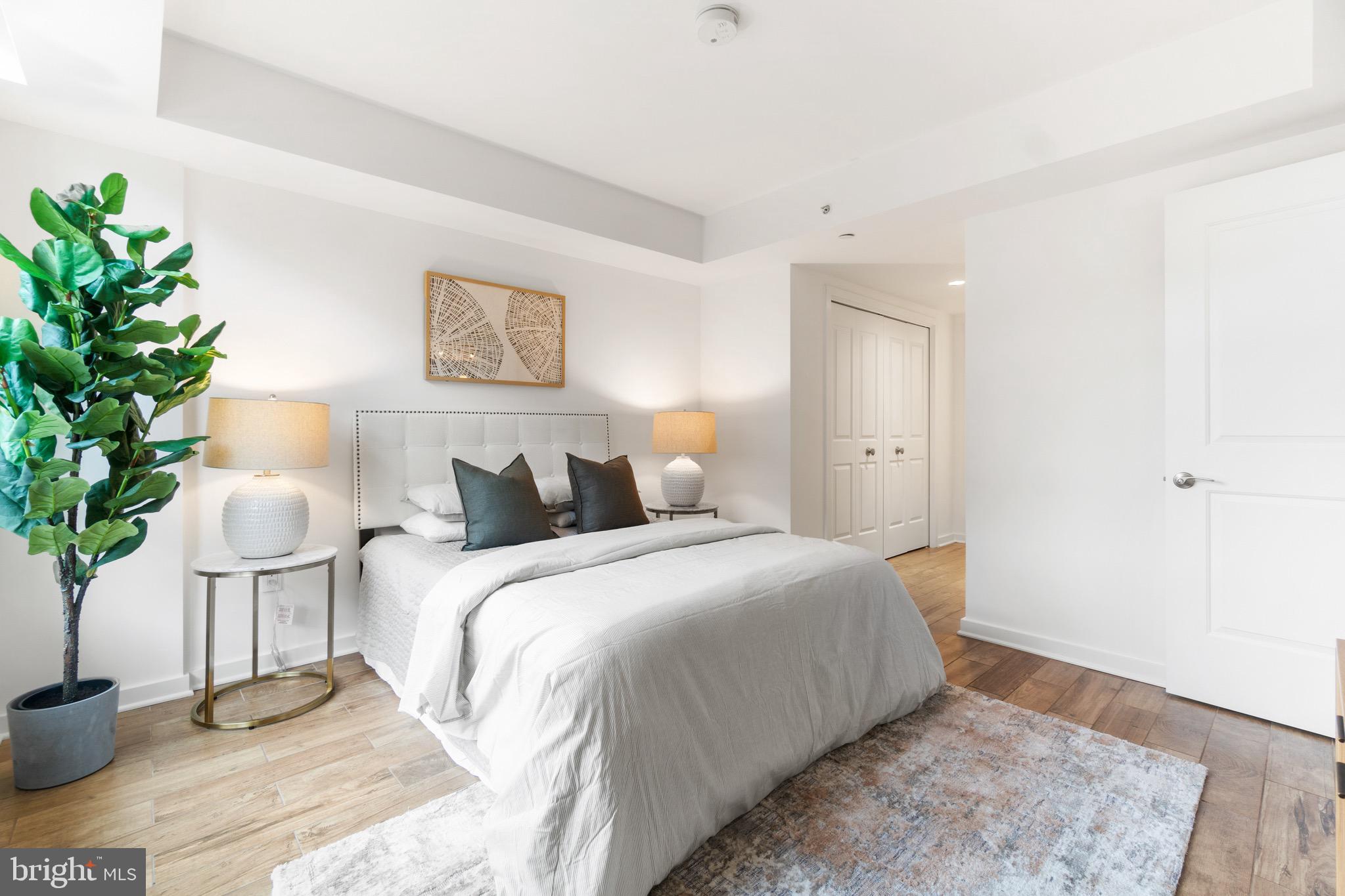 1025 First Street Southeast, Unit 1010 Washington, DC 20003 - Photo 17 of 36 a bedroom with bed and a potted plant