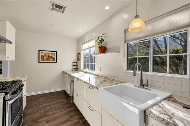 a bathroom with a sink mirror and a shower