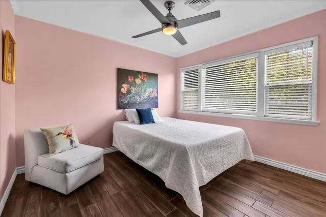 a view of backyard with table and chairs and potted plants
