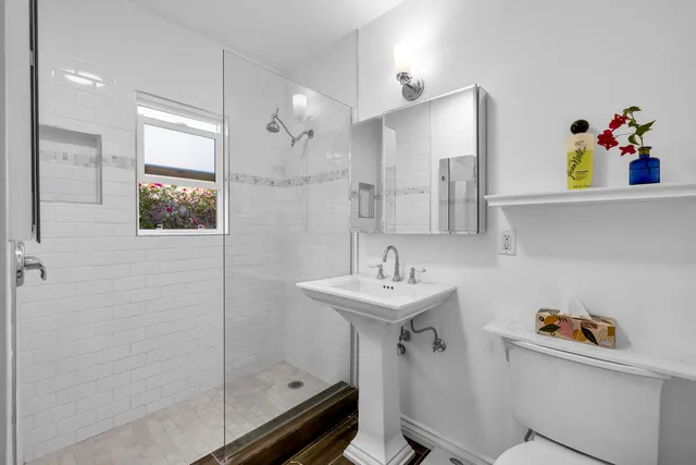 a front view of a house with a yard and a fountain