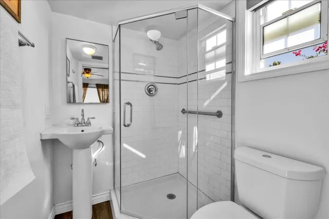 an aerial view of residential houses with city and green space