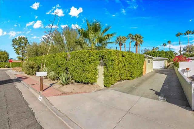 a patio with yard glass top table and chairs