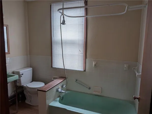a bathroom with a toilet and a shower