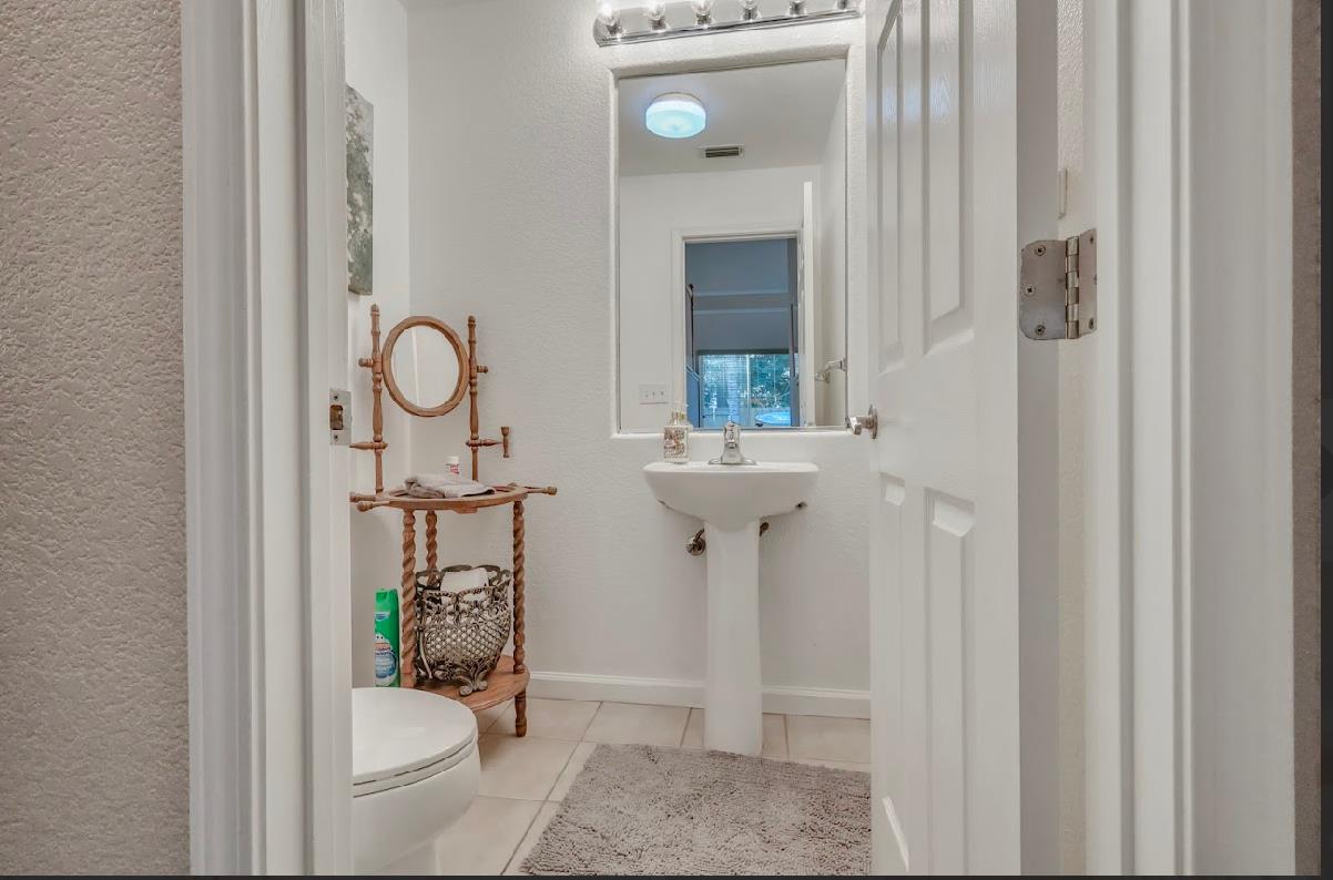 10647 Spring Creek Place Stockton, CA 95209 - Photo 12 of 24 a bathroom with a sink toilet and shower