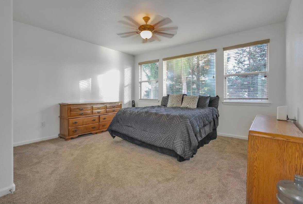 10647 Spring Creek Place Stockton, CA 95209 - Photo 16 of 24 a living room with a bed furniture and a window