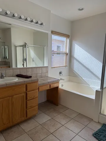 a bathroom with a bathtub sink and mirror